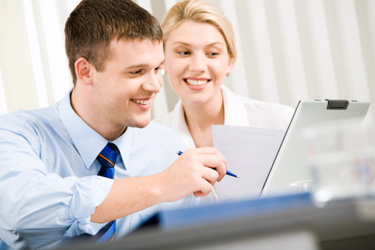 Man and woman writing marketing plan executive summary